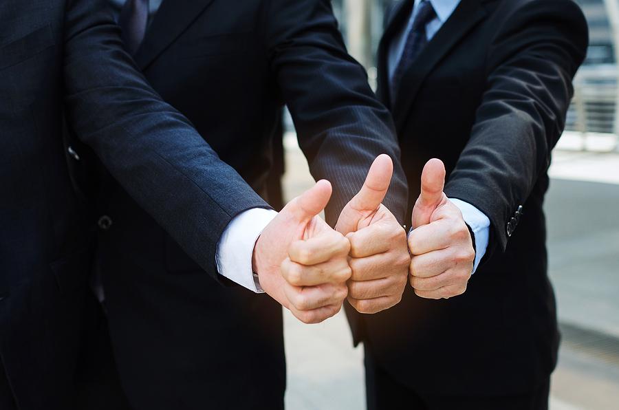 close up of hand group of handsome business people team in suit showing thumbs up as like sign together in the city, successful, support, meeting, partner, teamwork, community and connection concept